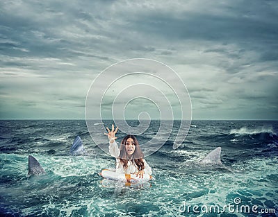 Businesswoman with lifebelt surrounded by sharks asks help Stock Photo