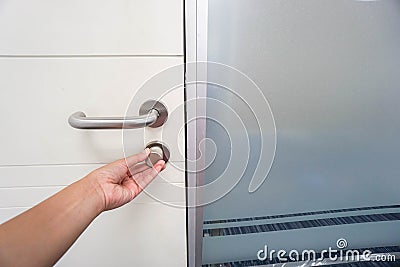 Businesswoman lock office door with left hand Stock Photo