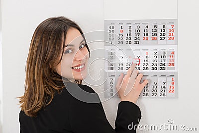 Businesswoman Looking At Calendar Stock Photo