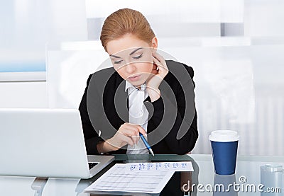 Businesswoman looking at calendar Stock Photo
