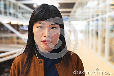 Businesswoman looking at camera in the corridor at office Stock Photo