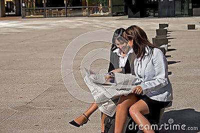 Businesswoman looking at a newspaper Stock Photo