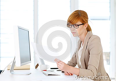 Businesswoman looking into papers Stock Photo