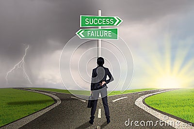 Businesswoman looking at sign of success or failure Stock Photo