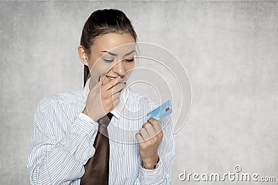 Businesswoman looks with great joy at the bank card Stock Photo