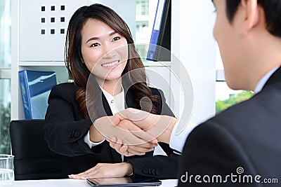 Businesswoman making handshake with a businessman Stock Photo