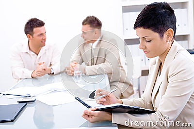 Businesswoman making notes Stock Photo