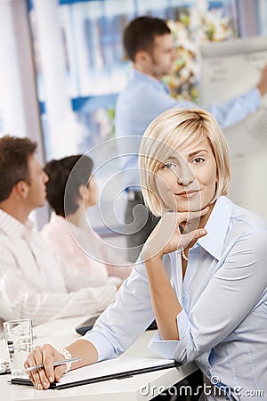 Businesswoman making notes on meeting Stock Photo