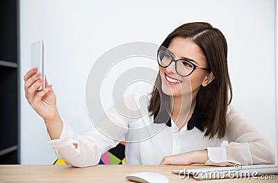 Businesswoman making selfie photo in office Stock Photo