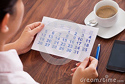 Businesswoman marking in calendar Stock Photo