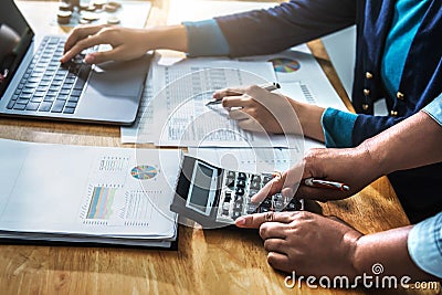 Businesswoman meeting time. accountant managers working with new startup project. using calculator and laptop in office Stock Photo