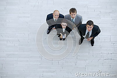 Businesswoman and men looking up Stock Photo