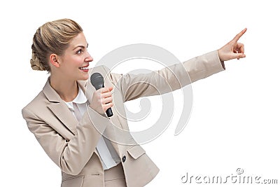 Businesswoman with microphone indicating something Stock Photo