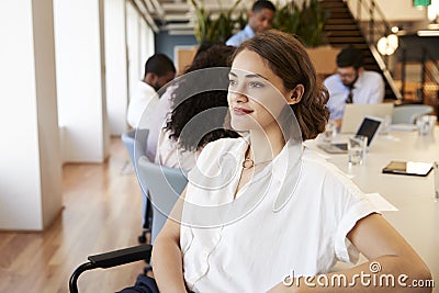 Businesswoman In Modern Office With Colleagues Meeting Around Table In Background Stock Photo