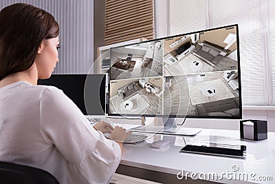 Businesswoman Monitoring CCTV Footage On Computer Stock Photo