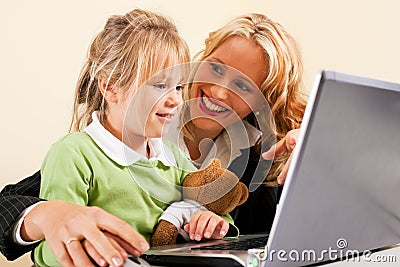 Businesswoman and mother showing kid the internet Stock Photo