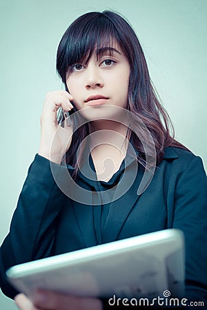 Businesswoman multi tasking busy with phone tablet. concept for business Stock Photo