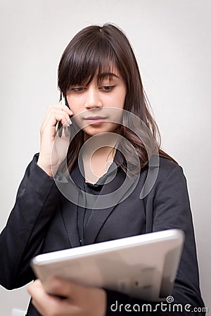 Businesswoman multi tasking busy with phone tablet. concept for business Stock Photo