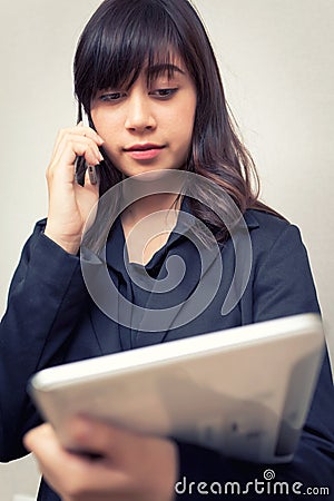 Businesswoman multi tasking busy with phone tablet. concept for business Stock Photo
