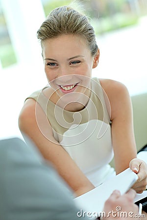 Businesswoman negotiating contract and smiling Stock Photo