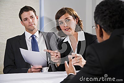 Businesswoman negotiating with men Stock Photo