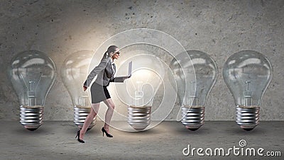 The businesswoman in new idea concept with light bulb Stock Photo