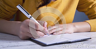 Businesswoman notebook and pen Stock Photo