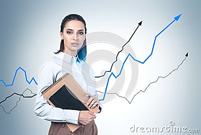 Businesswoman with notebooks, growing graphs Stock Photo