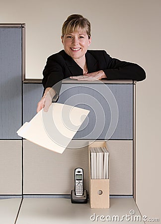 Businesswoman offering file folder Stock Photo