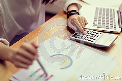 Businesswoman in office and use computer and calculator to perform financial accounting. Stock Photo