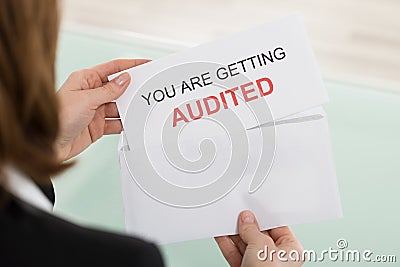 Businesswoman Opening Audit Letter Stock Photo