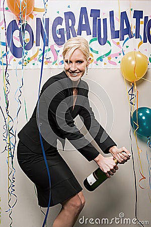 Businesswoman opening bottle of champagne Stock Photo