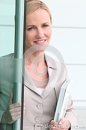 Businesswoman opening door Stock Photo