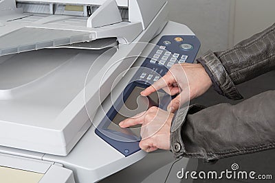 Businesswoman operating printer in office at work Stock Photo