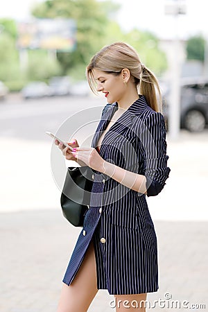 Businesswoman ordering taxi in mobile phone application Stock Photo