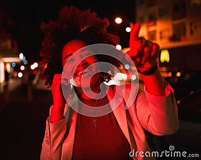 Businesswoman, phone call in street and city lights in the night, smile and pointing while waiting for taxi. Smartphone Stock Photo