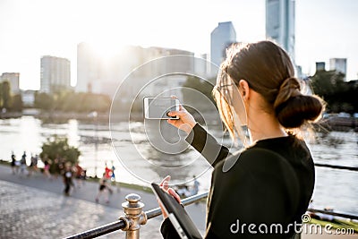 Businesswoman photographing Frankfurt cityscape Stock Photo