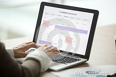 Businesswoman planning day using digital calendar on laptop, clo Stock Photo