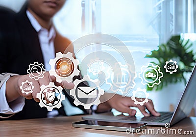 Businesswoman pointing at gears and icons. Operations management. Setting business goals, communication, workflow, problem solving Stock Photo