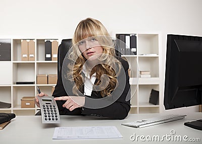 Businesswoman pointing to a calculator Stock Photo