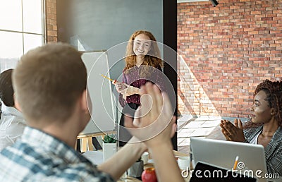 Businesswoman presenting corporate strategy pointing on flip chart Stock Photo