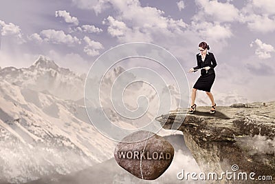 Businesswoman pull Loan rock outdoor Stock Photo