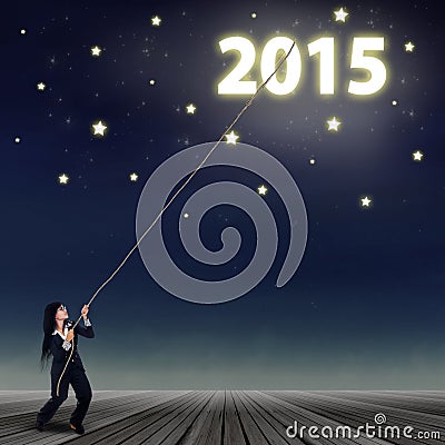 Businesswoman pulling number of 2015 Stock Photo