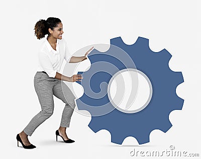 Businesswoman pushing a blue cogwheel Stock Photo