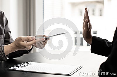 The businesswoman raised her hand to deny this conscience. Stock Photo