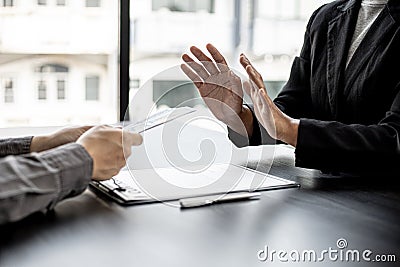 The businesswoman raised her hand to deny this conscience. Stock Photo