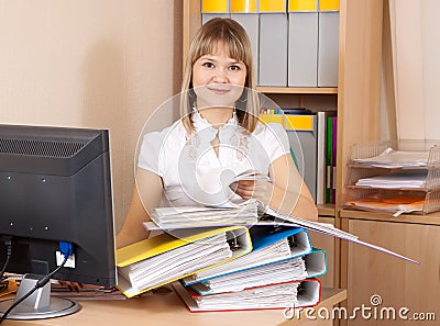 Businesswoman reading documents in office Stock Photo