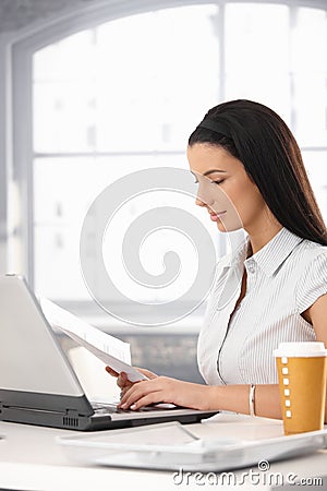 Businesswoman reviewing document Stock Photo