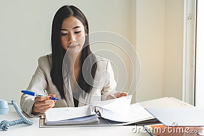 Businesswoman reviewing document in the office Stock Photo