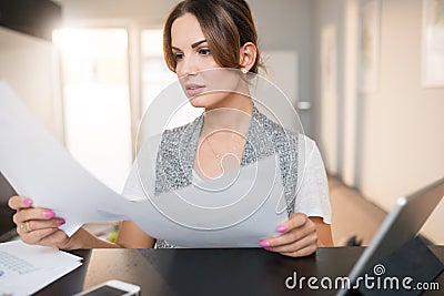 Businesswoman reviewing important documents Stock Photo